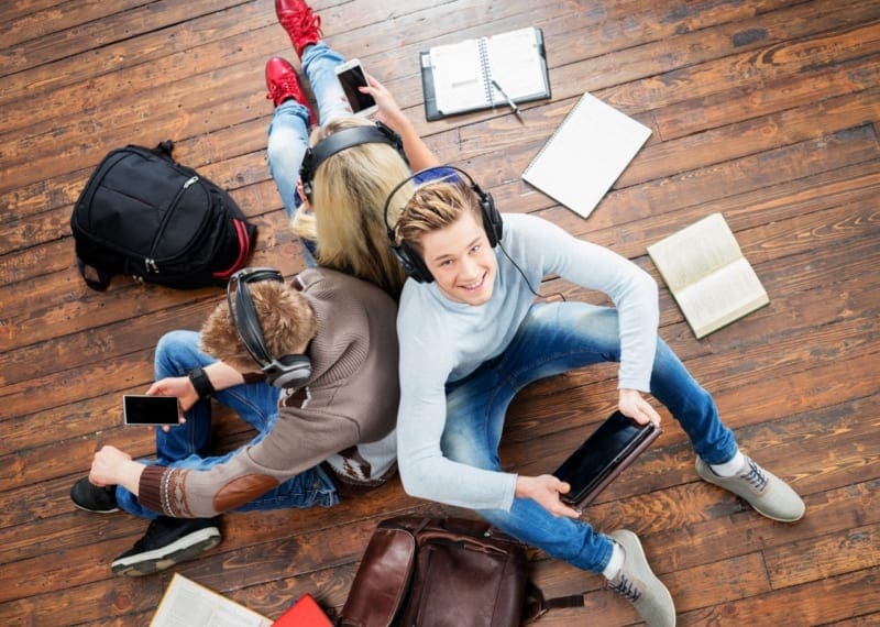 Teens listening on headphones